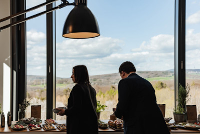 Two guests serving themselves at the delicious buffet catering