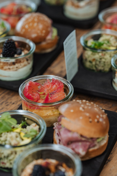 Mini burgers and various savory dishes served in glasses
