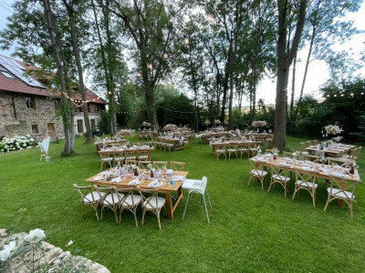 Tische und Stühle auf der Wiese der Außenlocation der Raumühle in Alzey